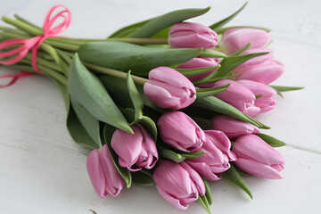 Pink tulips tied with ribbon, showcasing spring freshness and vibrant renewal