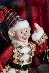 Christmas elf wearing Santa's costume and smiling 