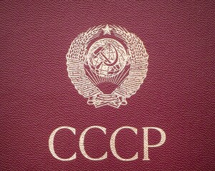 The coat of arms of the USSR on a red background. Close-up