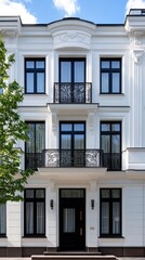Naklejka premium Balconies of a contemporary apartment building glow softly at twilight, showcasing a mix of dark windows and warm lights that create an inviting atmosphere in the city