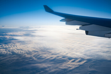 View of snow covered Greenland from an airplane window