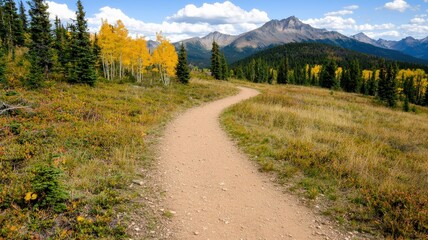 environmental consideration conservation nature concept. Winding trail through vibrant autumn landscape with mountains in background.
