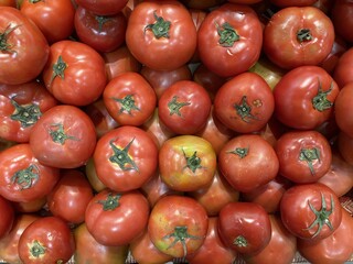 A Close-Up View of Fresh, Ripe Red Tomatoes Ready for Consumption or Culinary Use