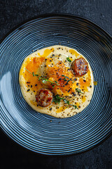 Creamy carbonara with sausage, garnished with herbs and spices, served in stylish bowl. This dish showcases rich flavors and delightful presentation