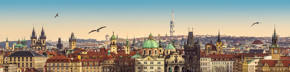 Panorama of Praha Old Town with ancient architecture, gothic spires, temples and medieval towers. City landscape of Prague historical center with all touristic landmarks for travel banner concept.