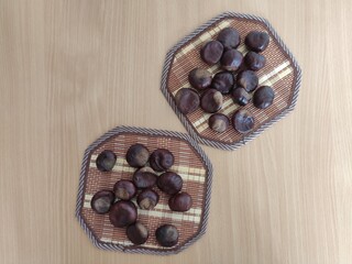 Shiny brown chestnuts on the table