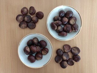 Shiny brown chestnuts on the table