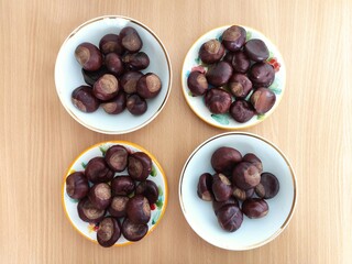 Shiny brown chestnuts on the table