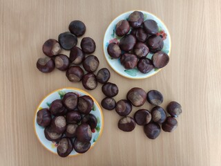 Shiny brown chestnuts on the table