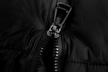 Dark lock with black zipper on clothes close-up. Zipper