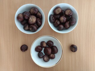 Shiny brown chestnuts on the table