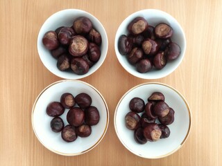 Shiny brown chestnuts on the table