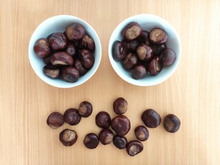 Shiny brown chestnuts on the table