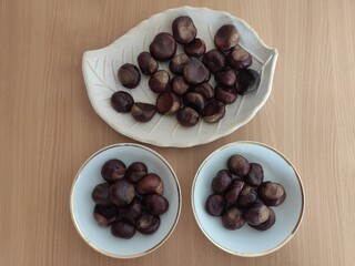 Shiny brown chestnuts on the table