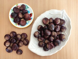 Shiny brown chestnuts on the table