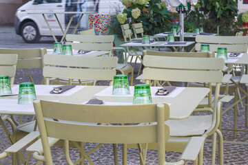 
outdoor cafe in the city with served tables for customers