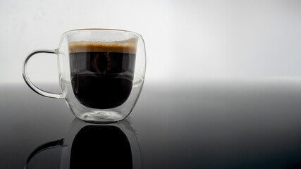 cup of coffee on the glass table 