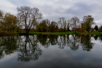 The reflection of the tree line along the River Thames at Runnymede, Surrey, UK