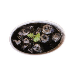 A dish of dark-colored seafood garnished with fresh herbs, served in an oval bowl.