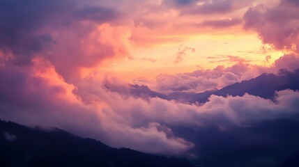 Obraz premium A Dreamy Sunset Over Mountain Peaks: Clouds and Colors in the Sky
