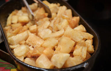 Cassava, Aipim, Macaxeira. Traditional Brazilian food. Brazilian cassava fried in a handmade clay bowl