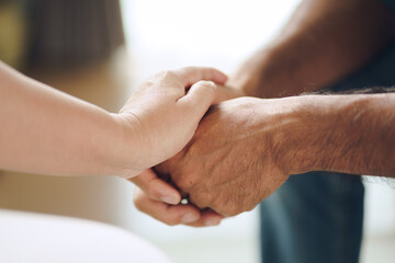 Female friend or family sitting and hold hands during cheer up to mental depress man