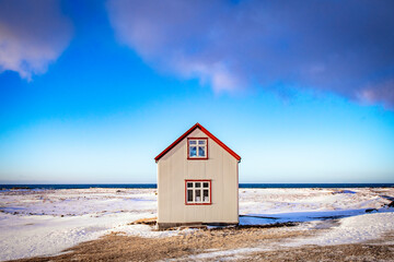 Wooden iceland house in winter landscape in Iceland.