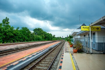 Fototapeta premium dramatic overcast landscape at kedung gedeh train station area, west java