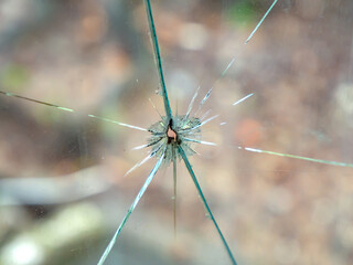 Broken window glass with rays of cracks