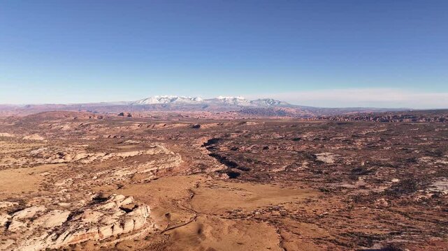 Aerial view of the distant La Sal mountains and of Arches National park from road 313 near Canyonlands national park, Utah, USA