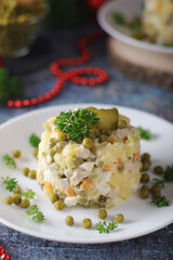 Olivier salad, traditional Russian dish, served on the plate	