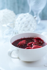 Traditional Christmas Borscht (Barszcz) with mushroom dumplings on bright background.