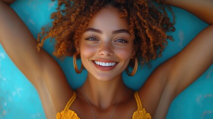 Young woman dancing joyfully in a pastel blue background, celebrating life