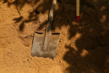 construction shovel in sand at suumer day