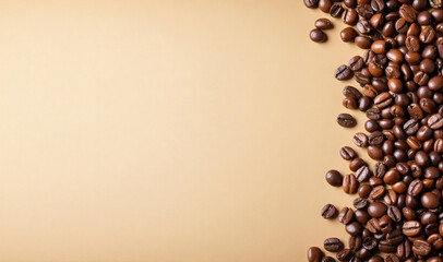Close-up of a collection of roasted coffee beans bringing out a rich color, are arranged in a semicircular pattern on the right side leaving copy space on the plain light colored background.