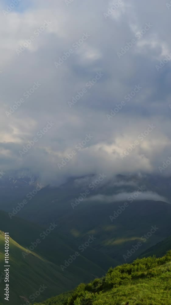 Wall mural beautiful landscape with mountains and clouds in dusk, caucasus, russia, timelapse. vertical video