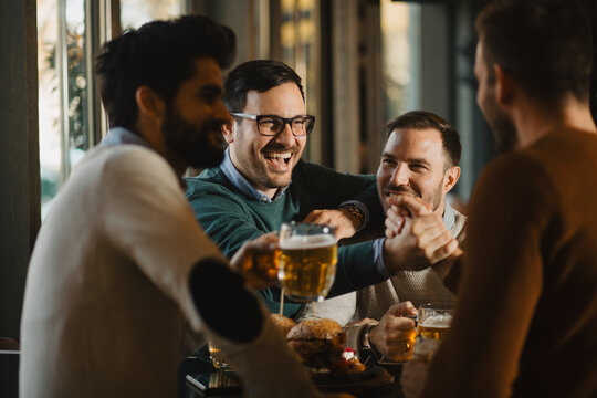 Group of friends have beer time in pub