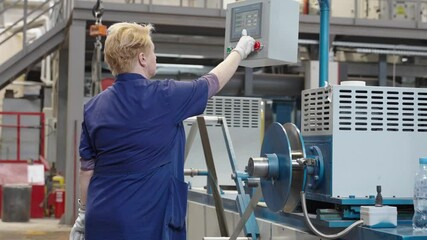 Industrial Operator Monitors Control Panel in Manufacturing Facility, Showcasing Safety and Technical Precision at 4K 50fps.