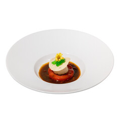 A gourmet dish featuring a creamy centerpiece garnished with herbs and flowers, surrounded by a rich sauce.