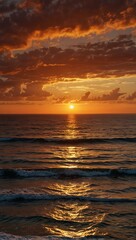 Obraz premium A vibrant orange sunset over the ocean horizon.