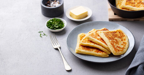 Traditional Scottish tattie potato scones on a plate. Grey background. Copy space.