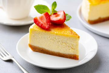 Cheesecake dessert with fresh strawberries. Grey background. Close up.