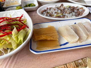 Korean food. Skate sashimi and white kimchi