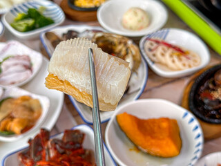 Korean food. Skate sashimi and white kimchi