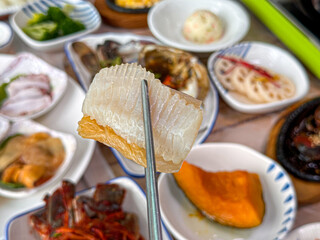 Korean food. Skate sashimi and white kimchi