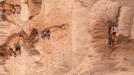 Aerial view road motor grader flatting dirt road surface, Motor grader road construction grader industrial machine construction site new road, Aerial view group excavator working on construction site.