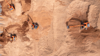 Aerial view road motor grader flatting dirt road surface, Motor grader road construction grader industrial machine construction site new road, Aerial view group excavator working on construction site.