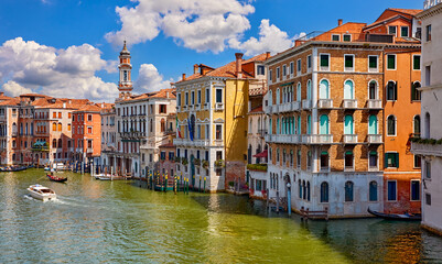 Venice, Italy. Boats and gondolas floating on Grand Canal among antique buildings traditional italian Venetian architecture. View from the famous Realto Bridge