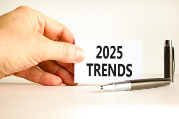 Planning 2025 trends new year symbol. Concept words 2025 Trends on beautiful white card. Beautiful white background. Businessman hand. Business 2025 trends new year concept. Copy space.