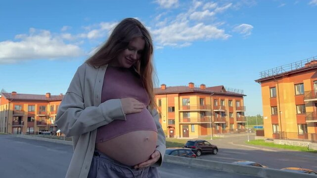 young pregnant woman walk near balding apartment